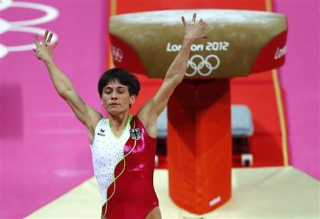 Oksana Chusovitina of Germany gestures after competing in the women's gymnastics vault final in the North Greenwich Arena during the London 2012 Olympic Games